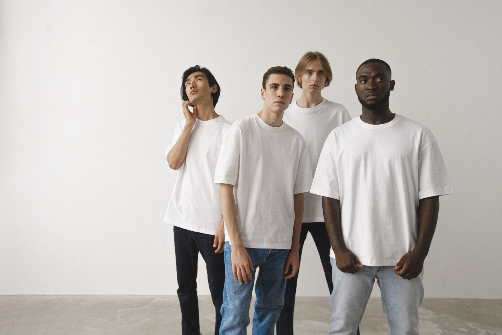 Group of diverse models wearing white t-shirts for men, showcasing a versatile and timeless fashion choice